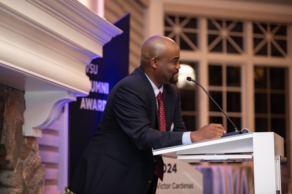 Quincy Williams speaking into microphone